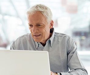 Man looking up information on computer